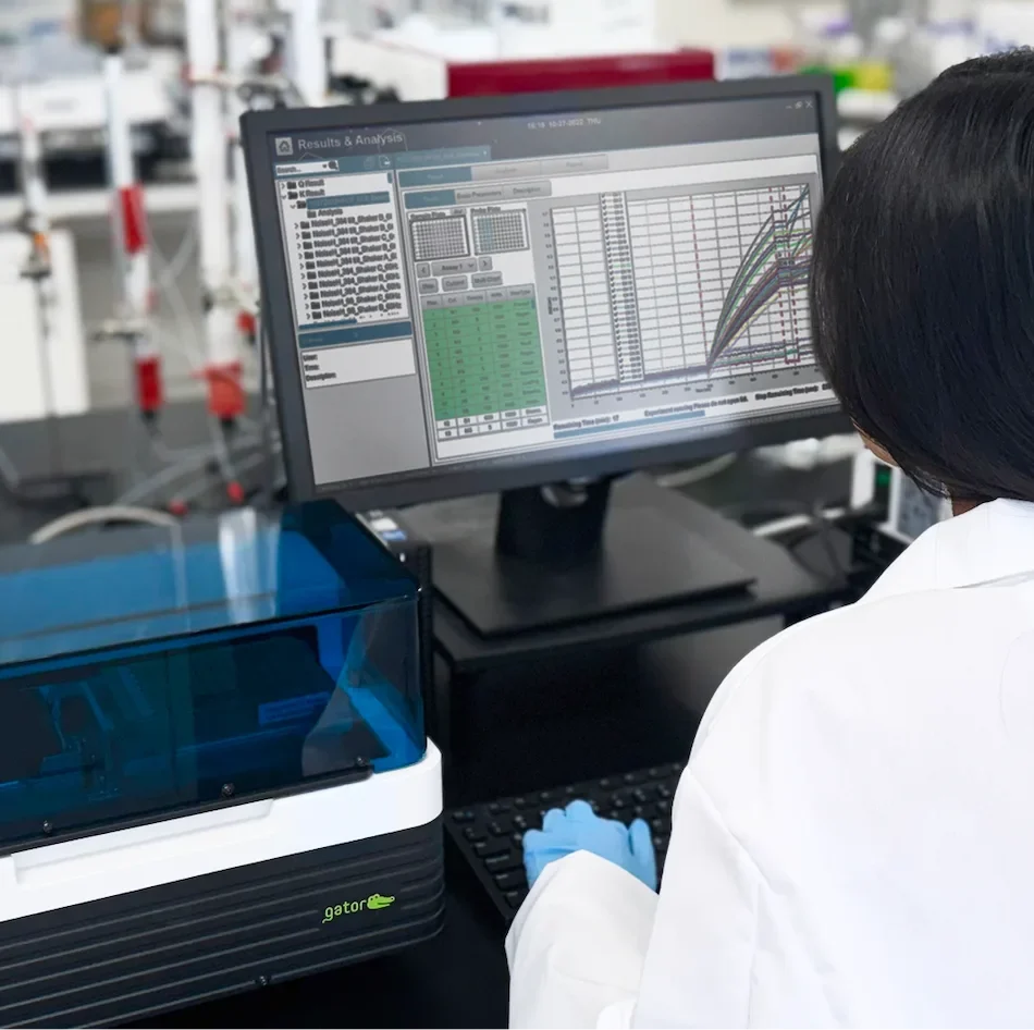 A scientist works at a computer looking at data