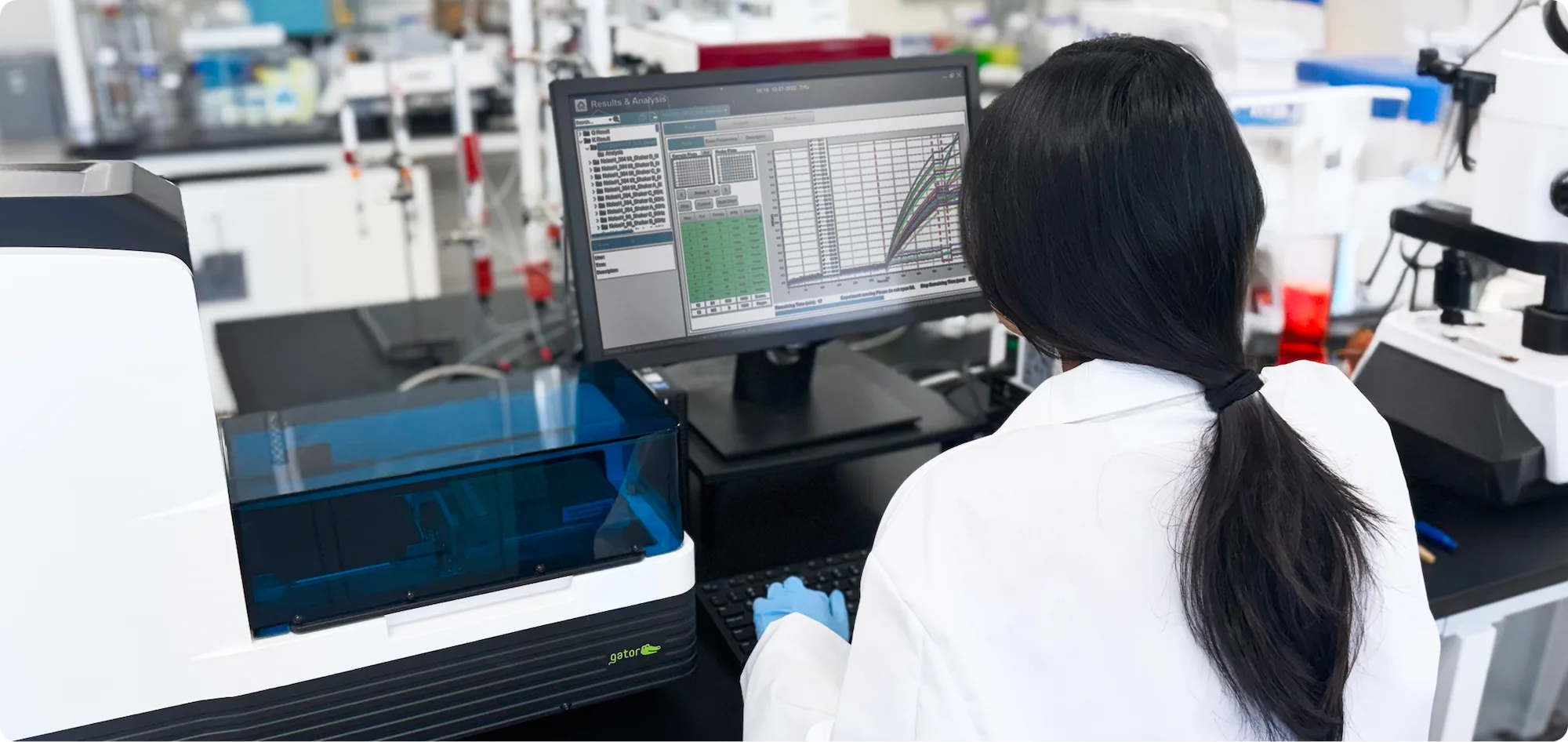 A scientist works at a computer looking at data